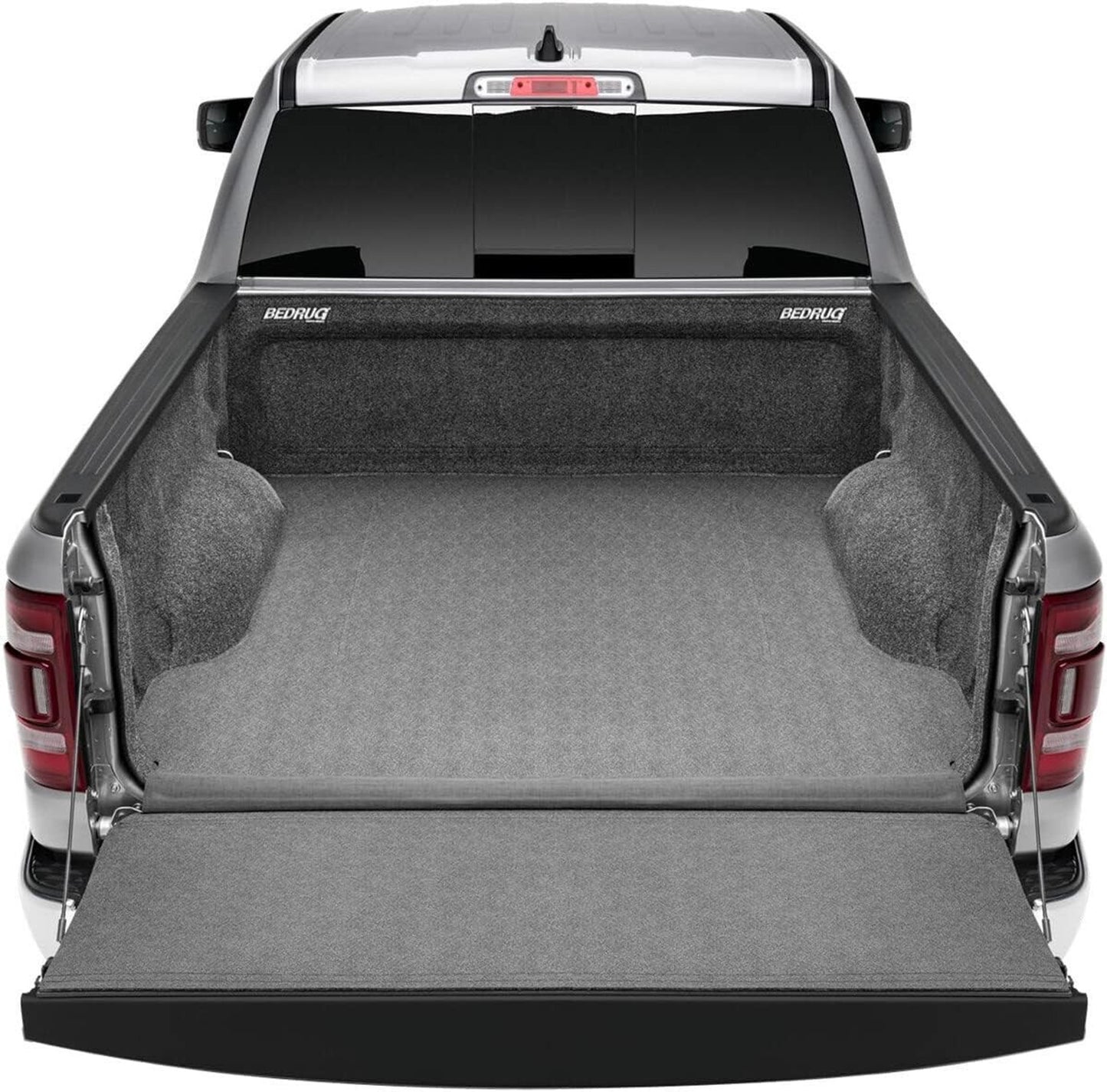 Truck bed with a gray mat and open tailgate, featuring BedRug branding.