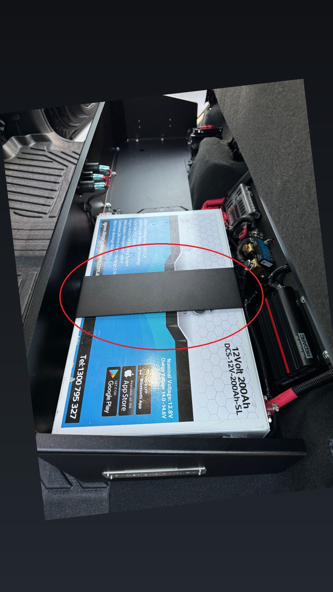 An aluminum battery mounting brace with a textured black powder coat finish.