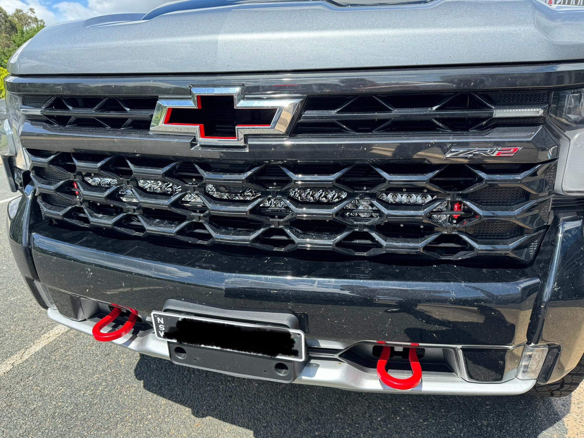 Greay Silverado ZR2 with behind grill light bar brackets and Stedi light