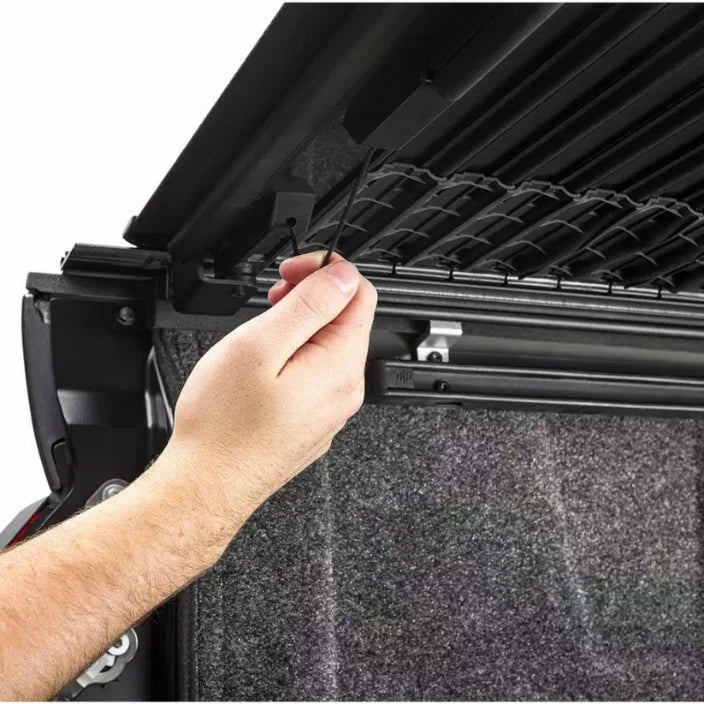 Person adjusting a grill with a close-up view of the hand and grill.
