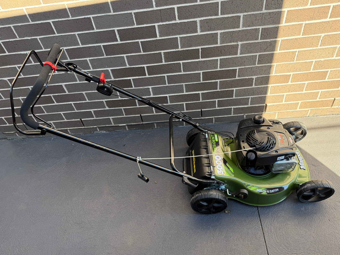 A Masport Walk Behind Lawn Mower with a 3D Printed Clip-on Brake Lever Holder