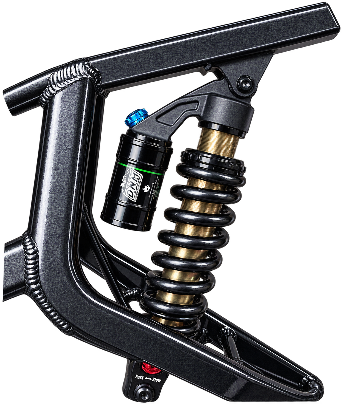 Close-up of a black mountain bike frame with a rear shock absorber featuring a black coil spring, gold shock body, and a black DNM brand canister with a blue top cap.